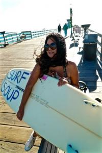 Donna Kay Lau at beach on pier and ocean with surfboard