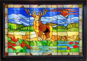 This B.P.O.E. Elks commissioned stained glass window with back lighting and stand, overall 78 ½ inches by 75 inches, should bring $500-$1,000 despite a few panel cracks.