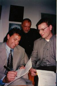 Steve Alten and Ken Atchity and One Other Hold Pen and Paper As They Sign The Contract For 'The Meg