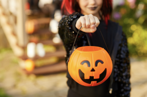 Teen holding pumpkin trick or treat bag