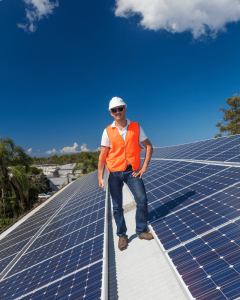 commercial solar installer in orange county standing on roof