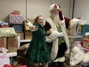 Santa is checking out the gifts that were donated to the families in need.