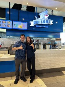 Emmanuel Avila and Jiyoung Lee pose in front of their new Torrance-based Uncle Sharkii location.
