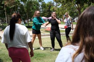 Photo of women being taught self defense. LATLC proudly sponsored a highly successful women's empowerment event, activities included a self defense class.